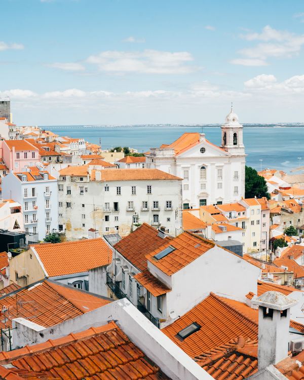 PTLIS Lisbon landscape photography of orange roof houses near body of water Tom Byrom.jpg